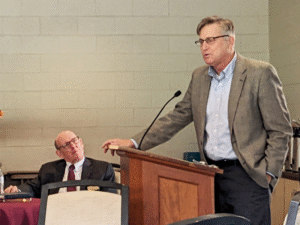 Kent Millard listens as Scott Kisker presents